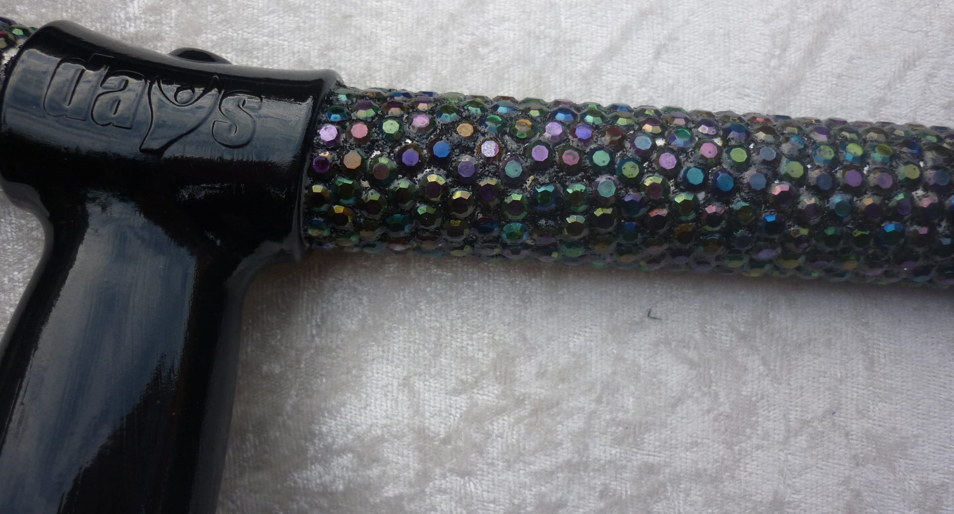 A close up Chameloen Crutch of the  iridescent coloured stones that shine like the Aurora Borealis on a beige cloth