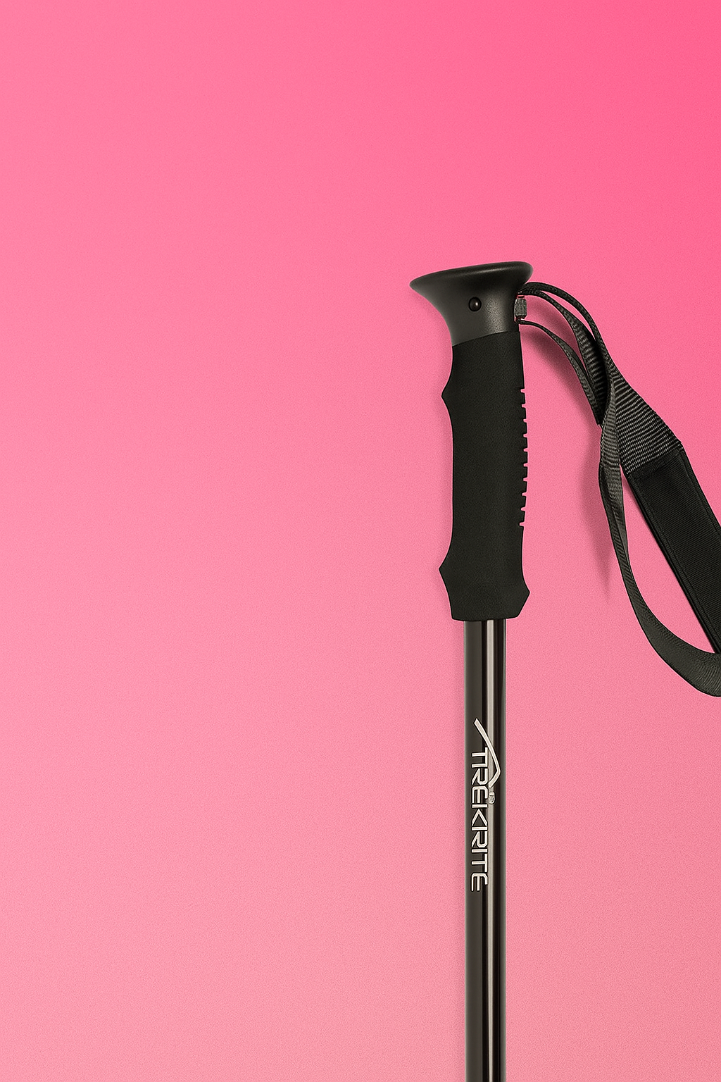 Black hiking pole with adjustable grip on a pink background