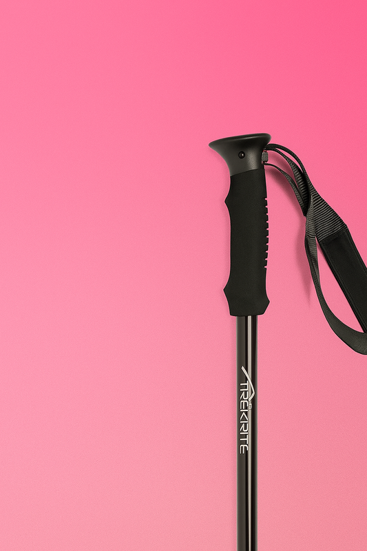 Black hiking pole with adjustable grip on a pink background