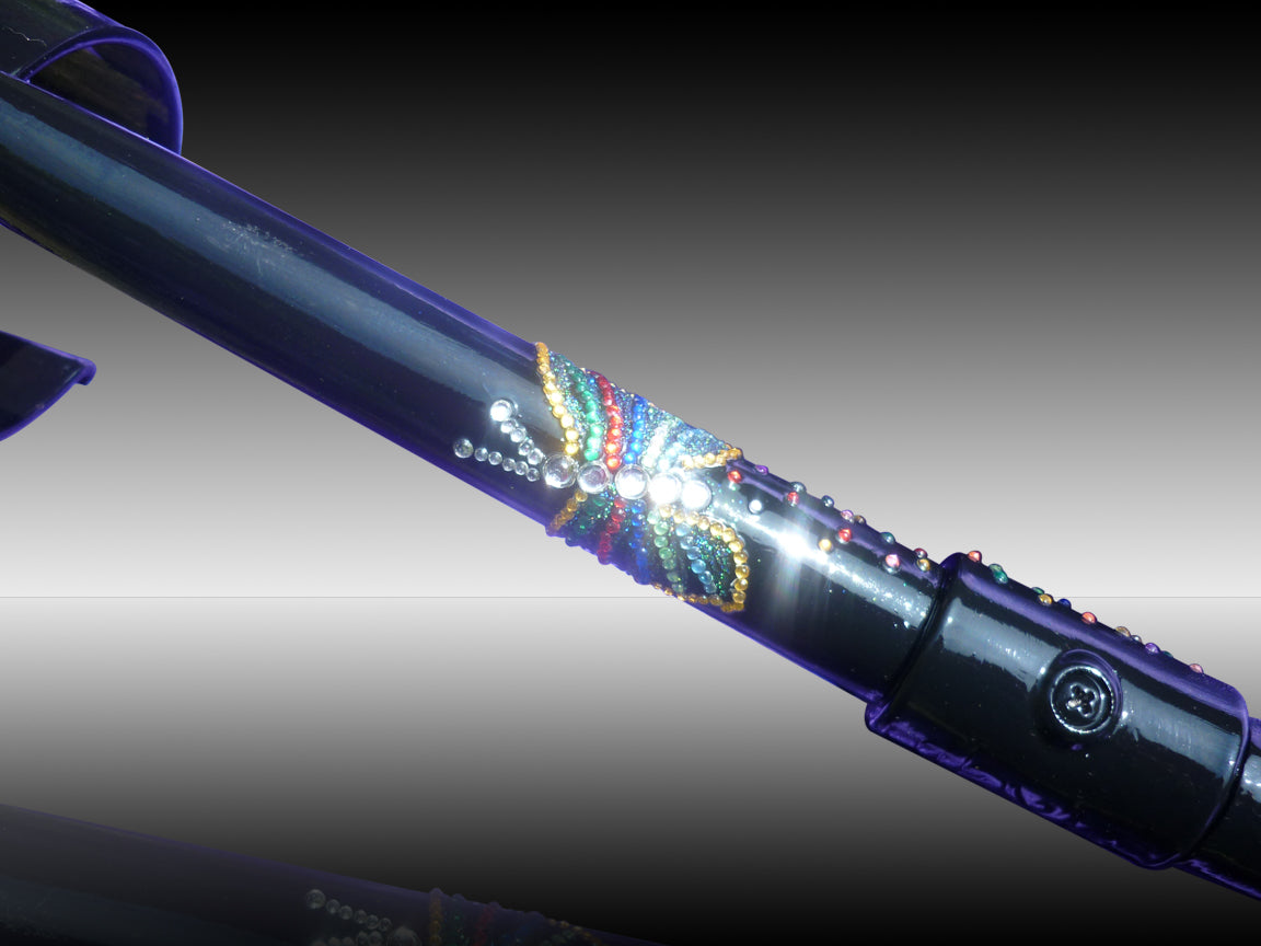 Flutterbye Crutch painted in Purple showing the butterfly decorated in  yellow, green, red, blue stripped diamanté with white diamanté for the body