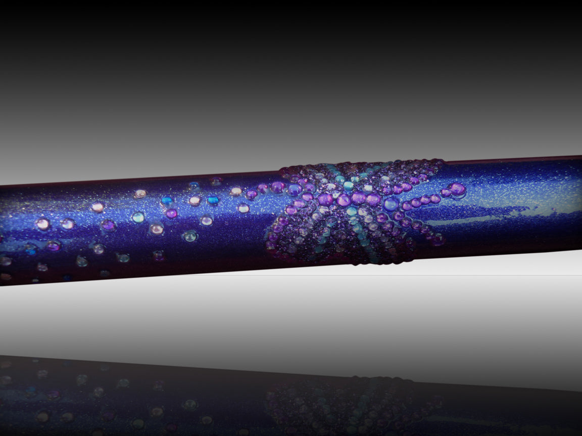 A close up of the GlitterWings which has a shimmery purple colour and is enriched with glitter butterflies picked out in purple and blue diamanté.