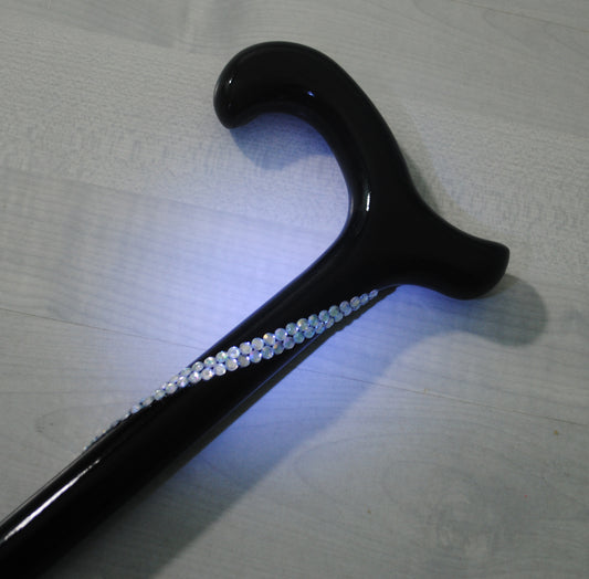 A close up of the Helenix Derby Cane in black with a row of white diamantés. The diamantés row roll down the crutch