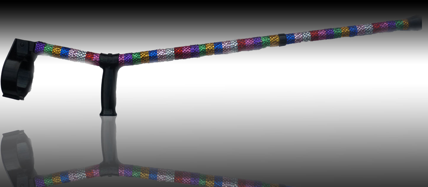 Juicy Lucy Crutch on reflective material showing a reflection. The crutch has rows of colours Rhinestones down.