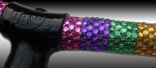 Juicy Lucy Crutch Showing a close up of the handle and lines of colours Rhinestones on the Crutch. The Rhinestones are coloured Pink, Purple, Green and Yellow