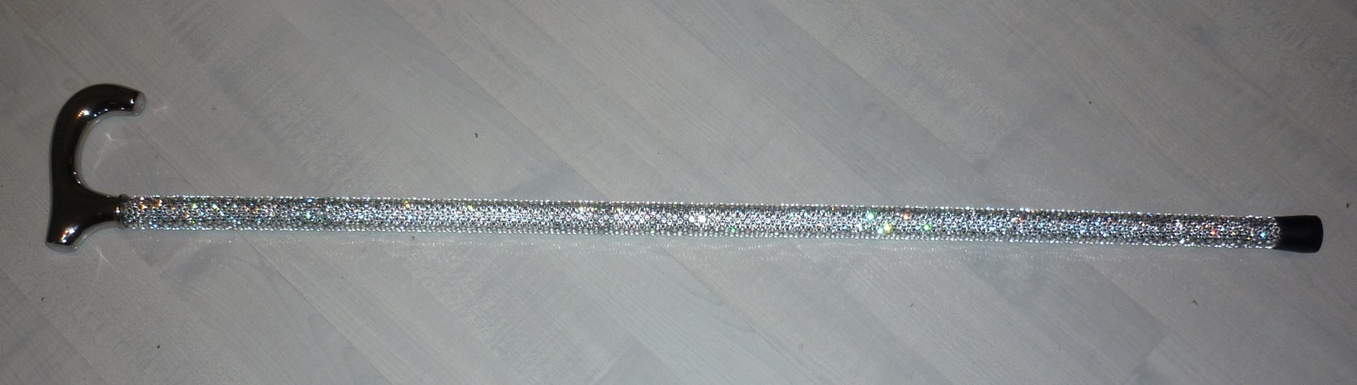 Austrian Crystal SparkleCane on a wood effect background.