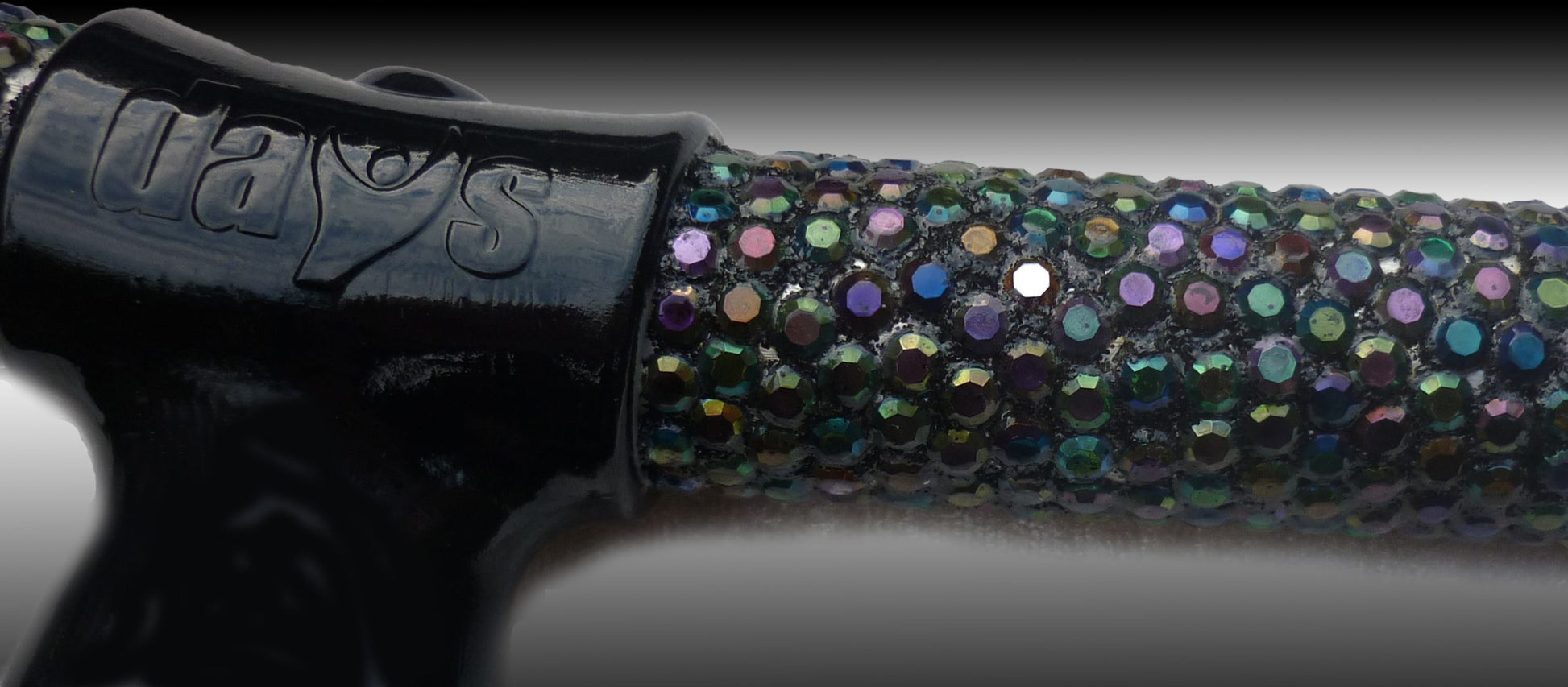 A close up of the diamanté with multiple colours and black handle on the Chameleon Folding Walking Stick 