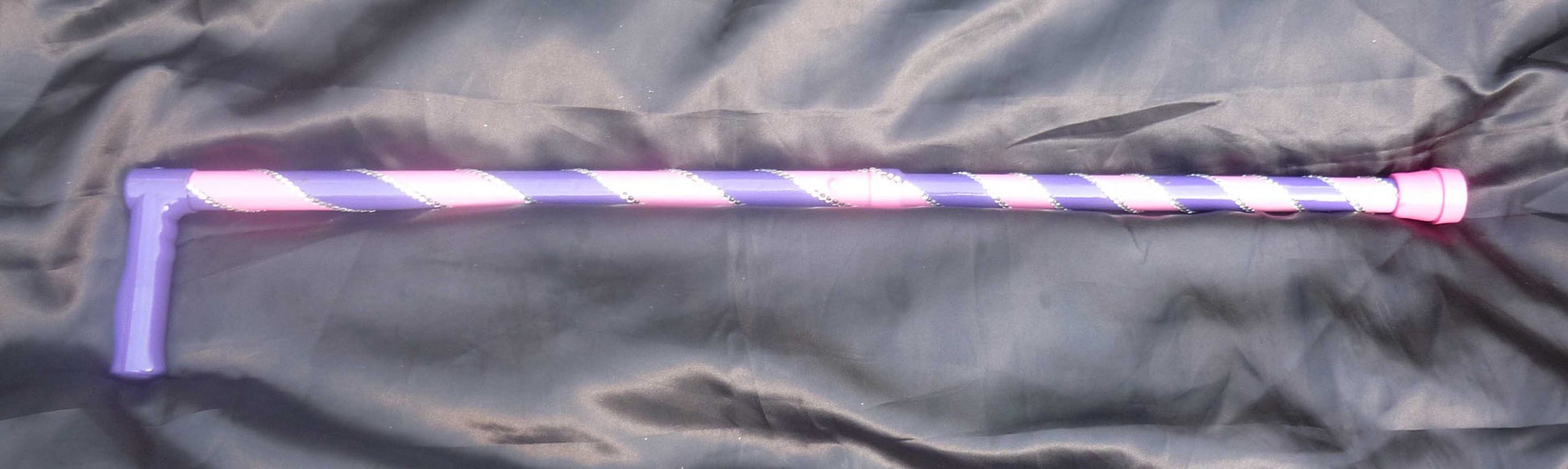 The Double Helenix walking stick in Purple and pink  angled thick stripes with silver diamanté in-between the colour changes.