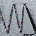 the white cane folded into 4 parts, showing the diamanté in multiple colours in a random design 